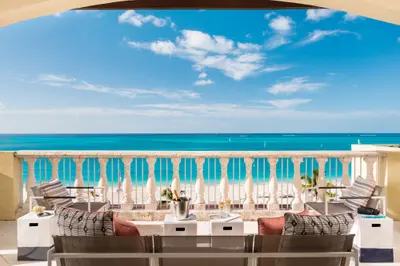 Ocean-facing Estate balcony at Grace Bay Club with dining and lounge seating