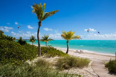 Long Bay beach beside The Shore Club with kiteboarders on the turquoise water