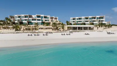 The Strand's beachfront buildings seen across clear turquoise water